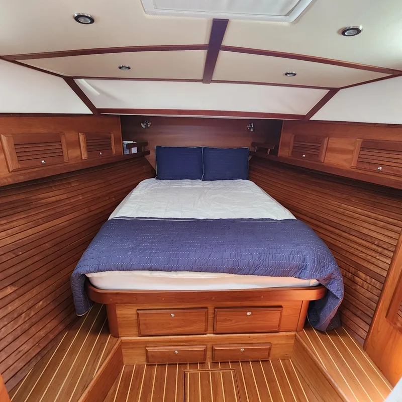 Slide: The Image of Luxurious wooden cabin interior of 2009 Sabre 34 Express yacht with cozy bed. - 36
