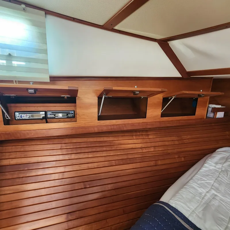 Slide: The Image of Interior of 2009 Sabre 34 Express boat with wooden storage compartments. - 38