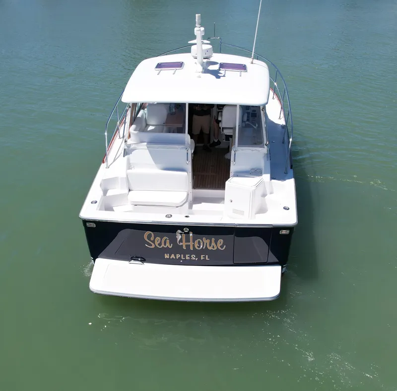 Slide: The Image of 2009 Sabre 34 Express boat named "Sea Horse" in Naples, FL, on calm water. - 4