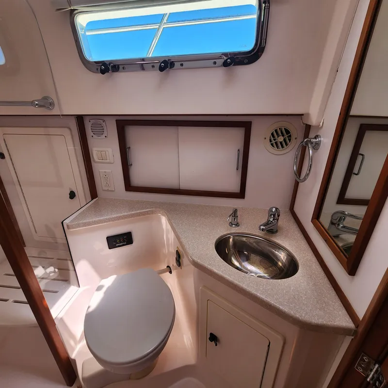 Slide: The Image of 2009 Sabre 34 Express yacht bathroom with sink, toilet, and window. - 47