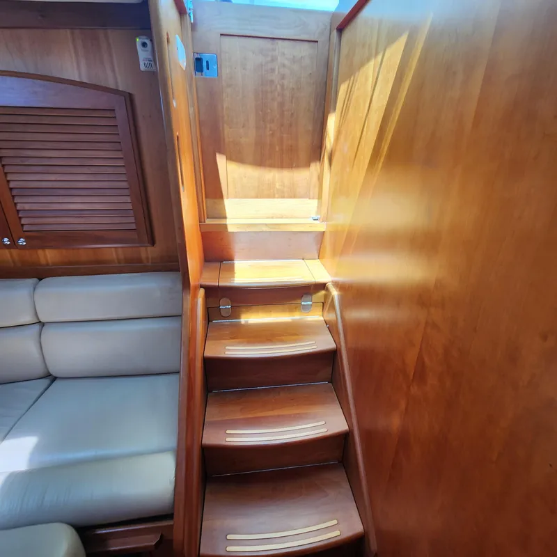 Slide: The Image of 2009 Sabre 34 Express interior with wooden stairs and beige seating. - 49