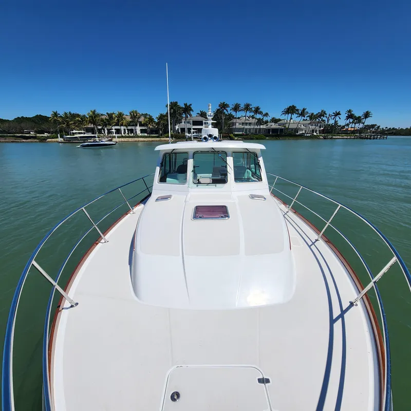Slide: The Image of 2009 Sabre 34 Express boat on calm water with palm trees in the background. - 6