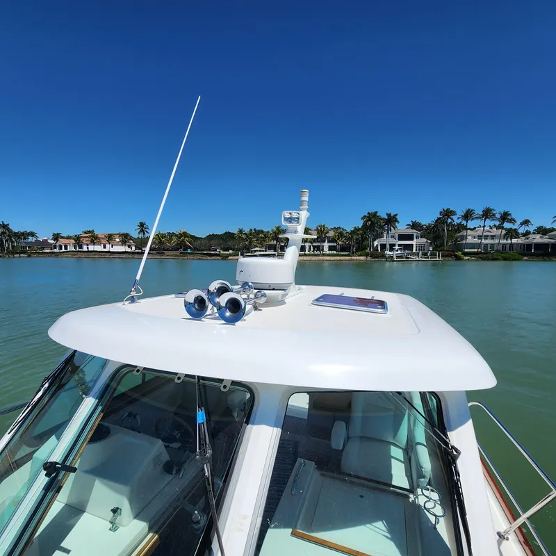 Slide: The Image of 2009 Sabre 34 Express boat on calm water with clear blue sky. - 7