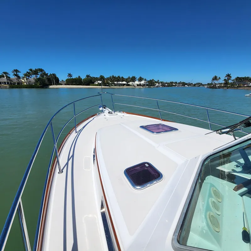 Slide: The Image of 2009 Sabre 34 Express boat cruising on a sunny day with clear blue skies. - 8