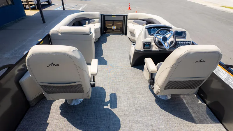 Slide: The Image of 2024 Barletta ARIA 22UC pontoon boat interior with plush seating and modern dashboard. - 10