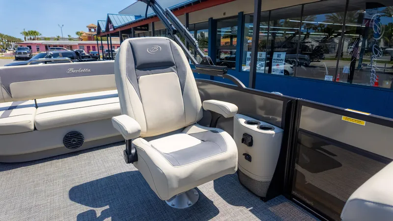 Slide: The Image of 2024 Barletta ARIA 22UC boat interior with captain's chair and cup holders. - 18