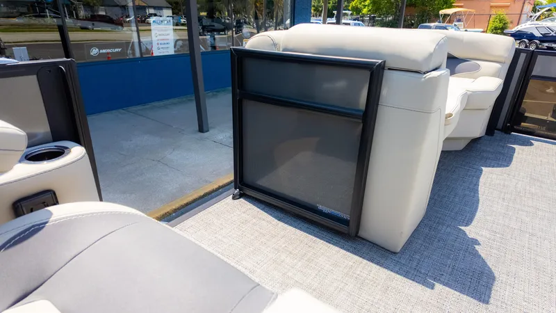 Slide: The Image of 2024 Barletta ARIA 22UC pontoon boat interior with beige seating and doggie view gate. - 19
