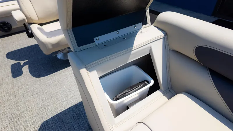 Slide: The Image of 2024 Barletta ARIA 22UC boat interior with built-in storage compartment and trash bin. - 22