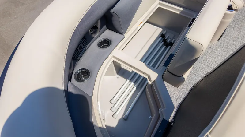 Slide: The Image of 2024 Barletta ARIA 22UC boat interior with storage compartment and cup holders. - 23