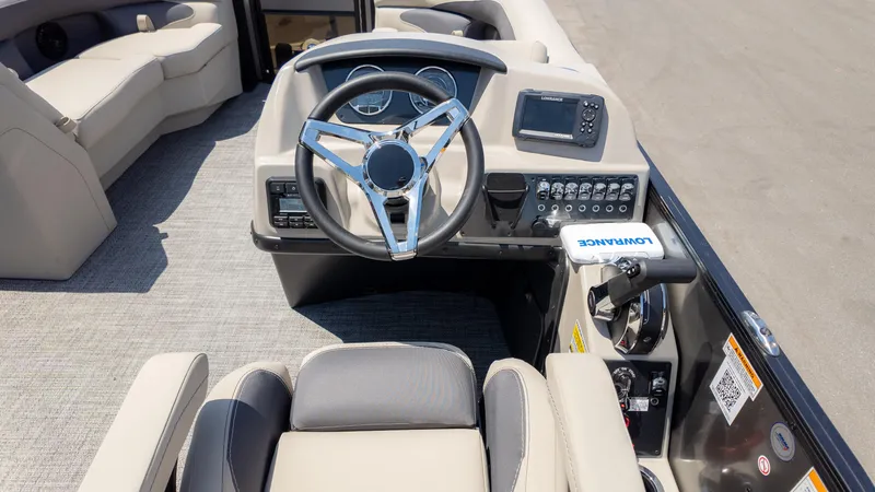 Slide: The Image of 2024 Barletta ARIA 22UC boat interior with steering wheel and control panel. - 24