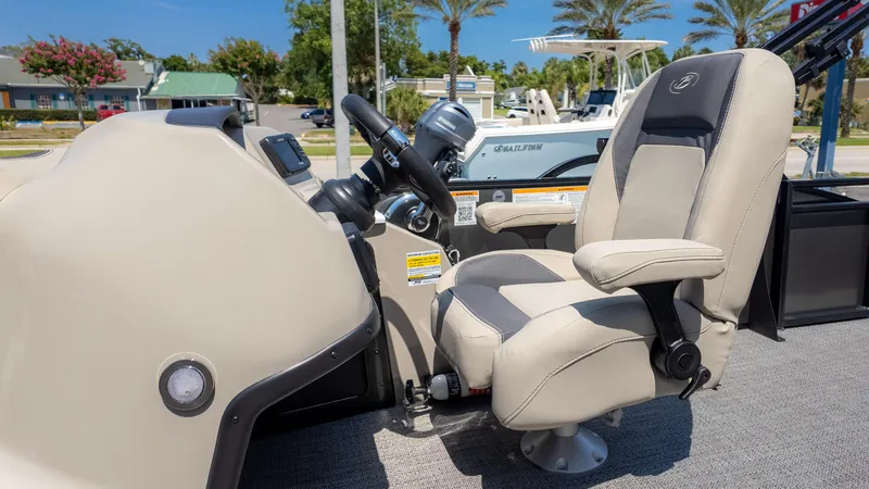 Slide: The Image of 2024 Barletta ARIA 22UC boat helm with luxurious captain's chair and steering wheel. - 26