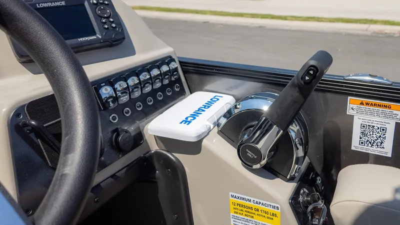 Slide: The Image of 2024 Barletta ARIA 22UC boat dashboard with steering wheel and control panel. - 31