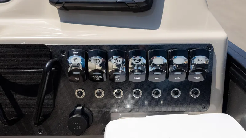 Slide: The Image of Control panel of 2024 Barletta ARIA 22UC boat with labeled switches. - 32