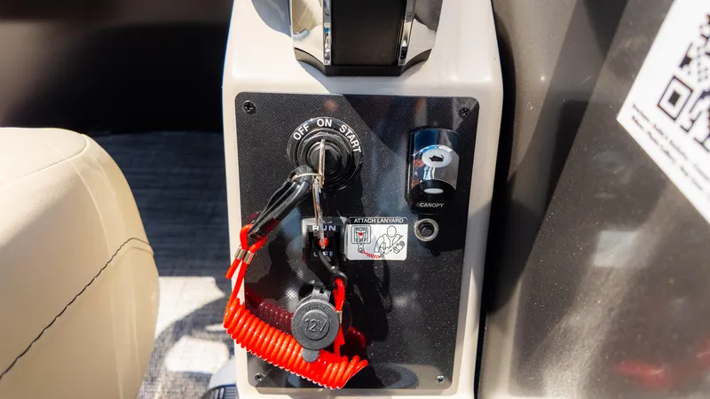 Slide: The Image of Control panel of 2024 Barletta ARIA 22UC boat with ignition and safety lanyard. - 33