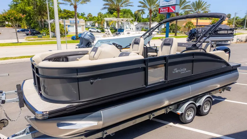 Slide: The Image of 2024 Barletta ARIA 22UC pontoon boat on trailer, parked in sunny lot. - 4