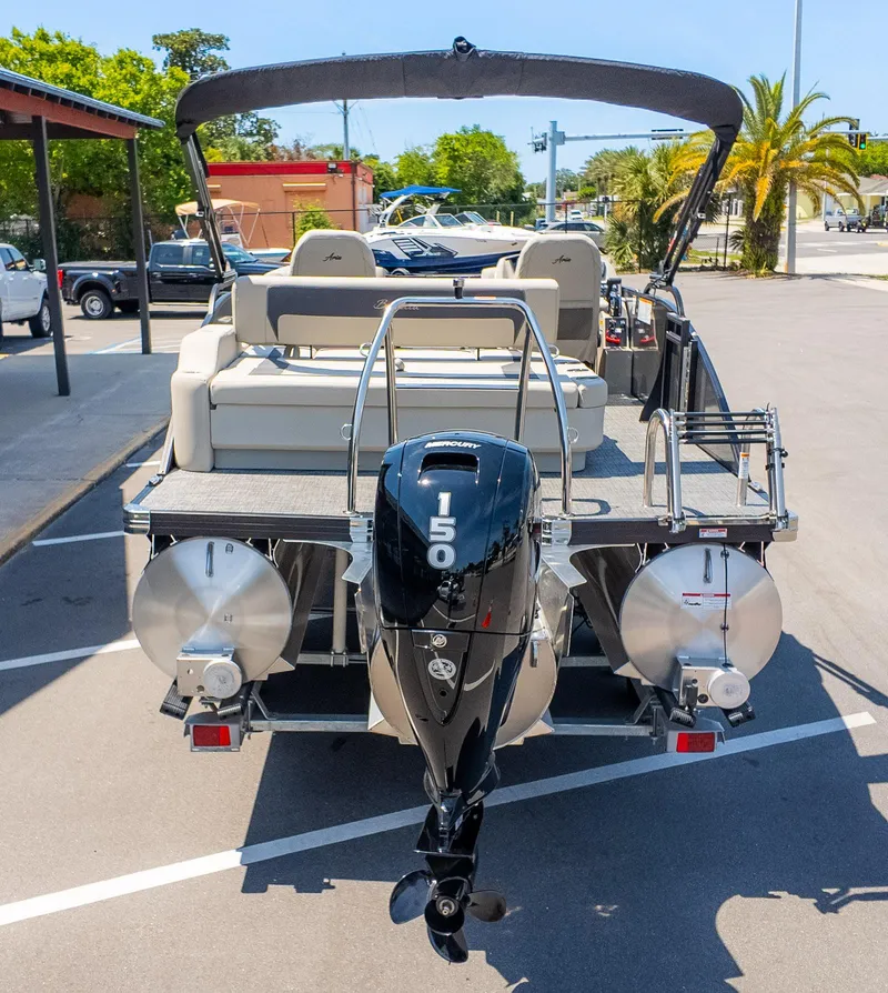 Slide: The Image of 2024 Barletta ARIA 22UC pontoon boat with Mercury 150 engine, parked outdoors. - 7