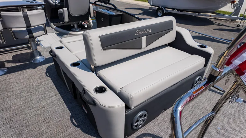 Slide: The Image of 2025 Barletta Cabrio 24UE boat interior with gray seating and cup holders. - 10