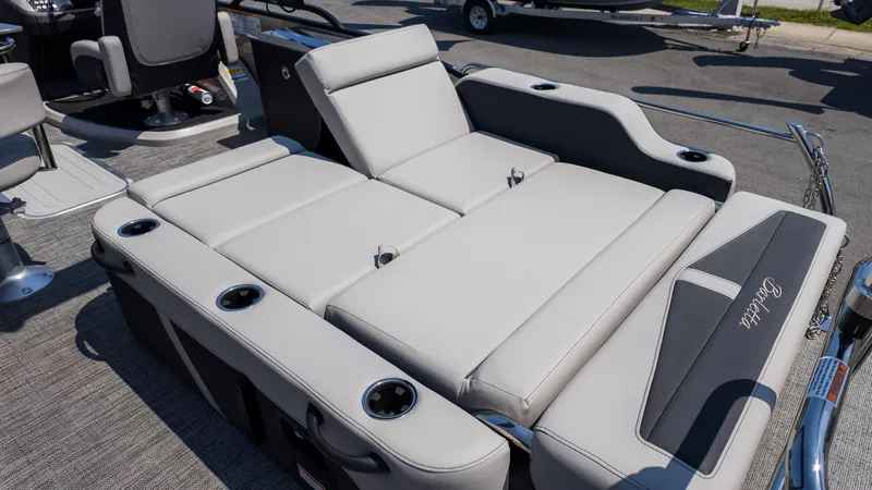 Slide: The Image of 2025 Barletta Cabrio 24UE boat interior with luxurious seating and cup holders. - 11
