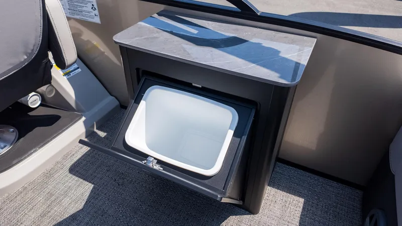 Slide: The Image of 2025 Barletta Cabrio 24UE interior with open storage compartment and sleek design. - 12