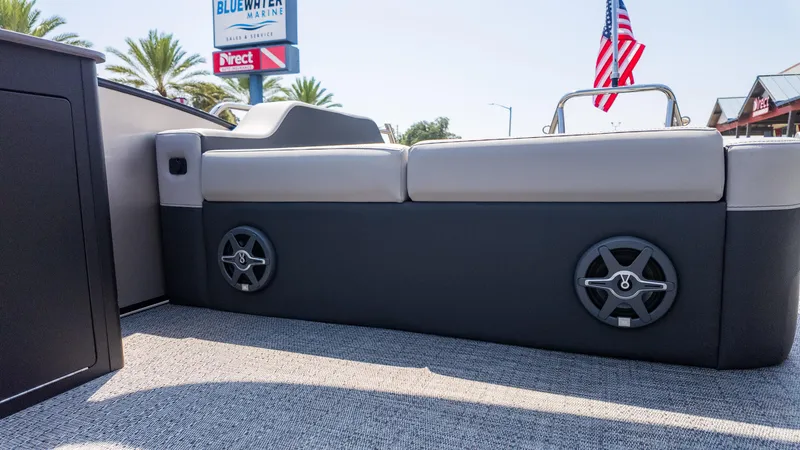 Slide: The Image of 2025 Barletta Cabrio 24UE boat interior with seating and speakers, showcasing modern design. - 13
