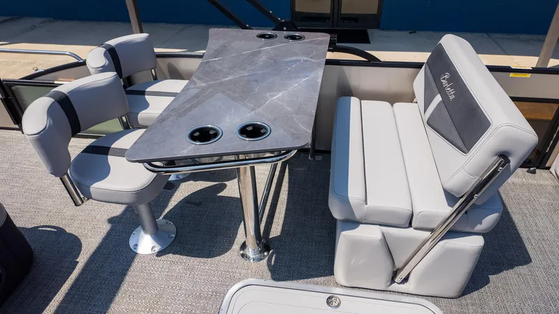 Slide: The Image of 2025 Barletta Cabrio 24UE boat interior with sleek seating and modern table design. - 15