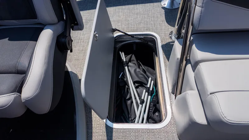 Slide: The Image of Storage compartment in 2025 Barletta Cabrio 24UE boat, featuring seats and equipment. - 16