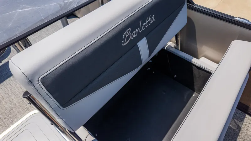 Slide: The Image of 2025 Barletta Cabrio 24UE boat seat with storage compartment open. - 17