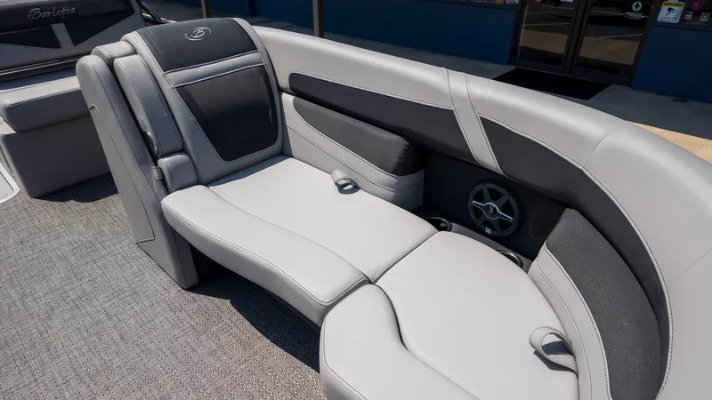Slide: The Image of 2025 Barletta Cabrio 24UE boat interior with luxurious gray seating and speaker system. - 19