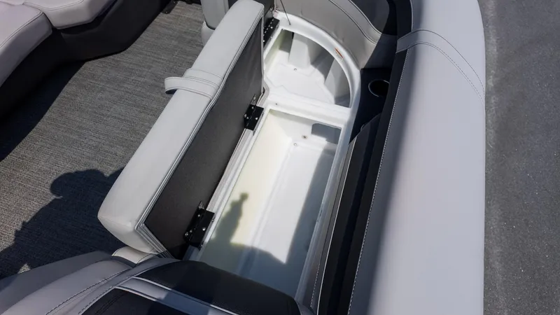 Slide: The Image of 2025 Barletta Cabrio 24UE boat interior storage compartment with open seat. - 21