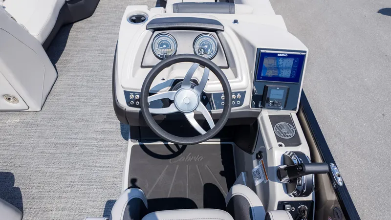 Slide: The Image of 2025 Barletta Cabrio 24UE boat dashboard with steering wheel and navigation display. - 23