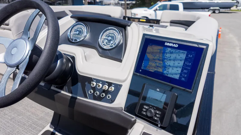 Slide: The Image of 2025 Barletta Cabrio 24UE dashboard with steering wheel and Simrad navigation display. - 25