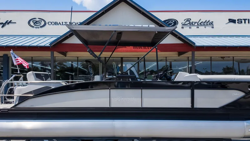 Slide: The Image of 2025 Barletta Cabrio 24UE pontoon boat displayed at dealership. - 27