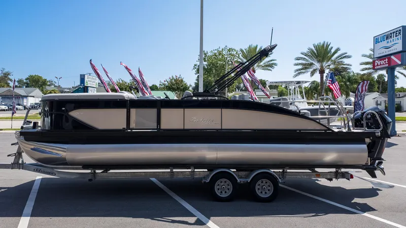 Slide: The Image of 2025 Barletta Cabrio 24UE pontoon boat on trailer at Bluewater Marine dealership. - 4