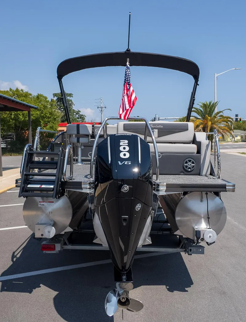 Slide: The Image of 2025 Barletta Cabrio 24UE pontoon boat with 200 V6 engine, parked outdoors. - 7