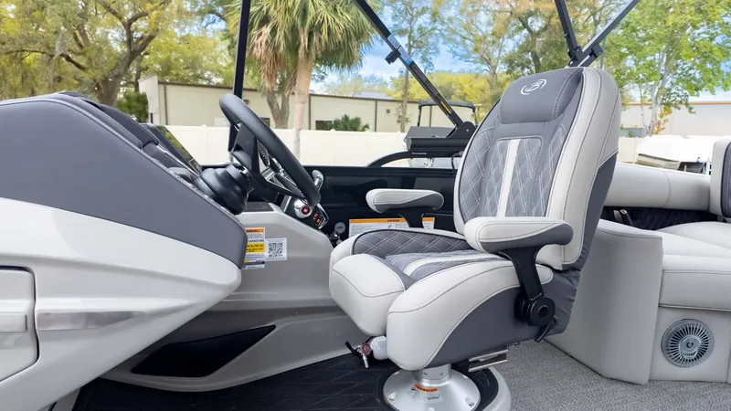 Slide: The Image of 2025 Barletta Lusso 23M boat interior with luxury captain's chair and steering console. - 28