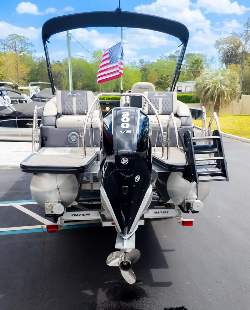 Slide: The Image of 2025 Barletta Lusso 23M pontoon boat with 300 V8 engine and American flag. - 7