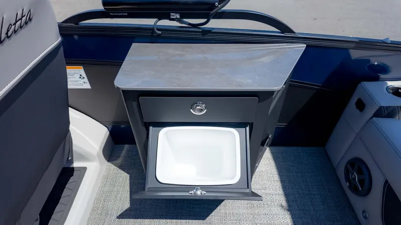 Slide: The Image of 2025 Barletta Lusso 25UE boat interior with a built-in sink and storage unit. - 12
