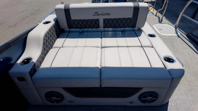 Slide: The Image of Luxurious seating on 2025 Barletta Lusso 25UE pontoon boat, featuring elegant upholstery and cup holders. - 13