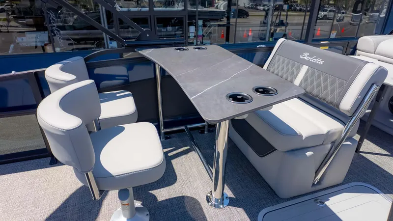 Slide: The Image of 2025 Barletta Lusso 25UE boat interior with elegant seating and table setup. - 14