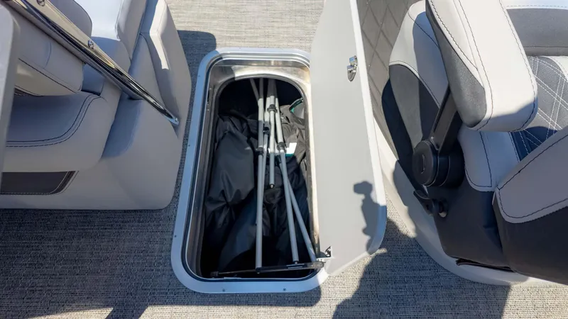 Slide: The Image of 2025 Barletta Lusso 25UE boat storage compartment with folded equipment inside. - 24