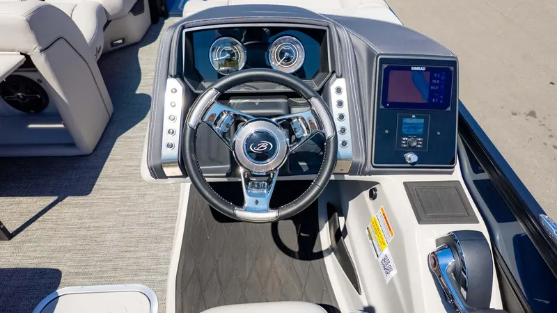 Slide: The Image of 2025 Barletta Lusso 25UE boat dashboard with steering wheel and digital display. - 26
