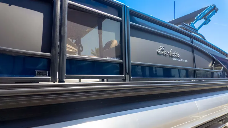 Slide: The Image of 2025 Barletta Lusso 25UE pontoon boat, sleek design with "Coastal Edition" branding. - 5
