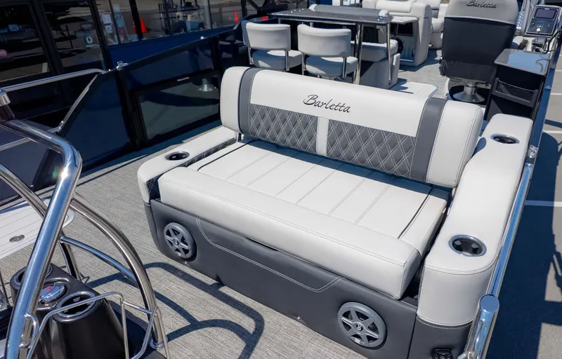 Slide: The Image of 2025 Barletta Lusso 25UE luxury boat seating with elegant upholstery and cup holders. - 7