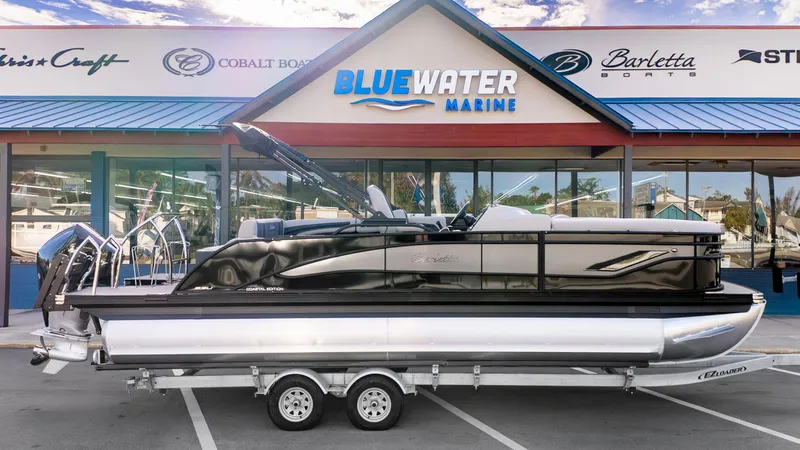 Slide: The Image of 2025 Barletta Corsa 23U pontoon boat displayed at Blue Water Marine dealership. - 1