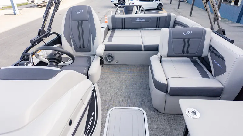 Slide: The Image of 2025 Barletta Corsa 23U boat interior with gray seating and steering wheel. - 10