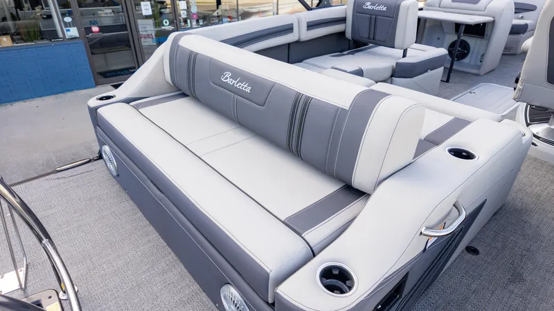 Slide: The Image of 2025 Barletta Corsa 23U boat interior with gray seating and cup holders. - 11