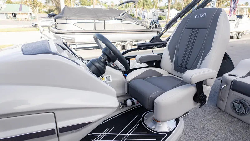 Slide: The Image of 2025 Barletta Corsa 23U boat helm with luxurious captain's chair and modern steering console. - 22
