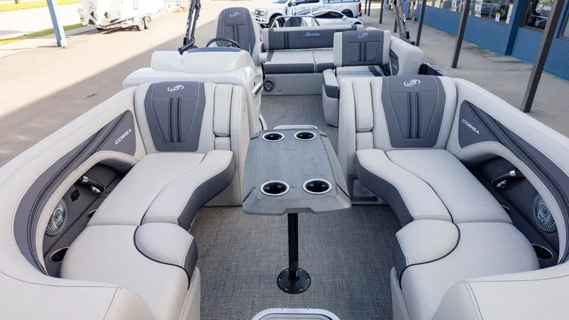 Slide: The Image of 2025 Barletta Corsa 23U pontoon boat interior with luxurious seating and table. - 3