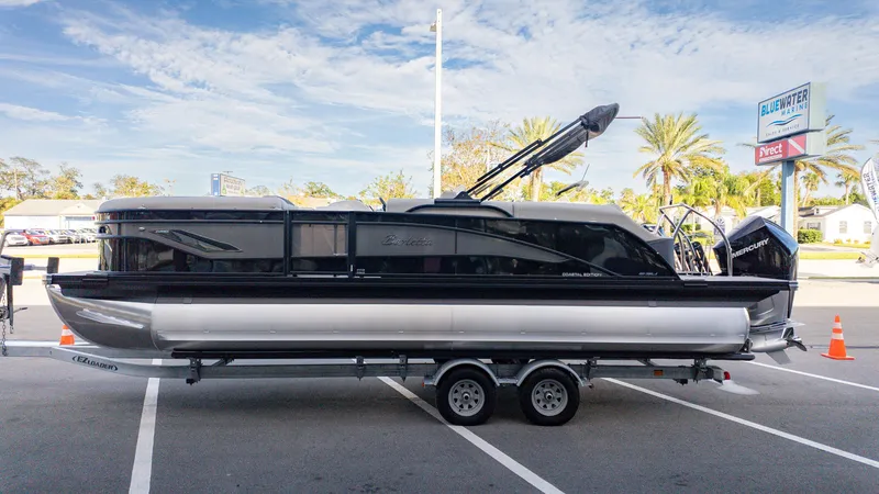 Slide: The Image of 2025 Barletta Corsa 23U pontoon boat on trailer at Bluewater Marine dealership. - 5