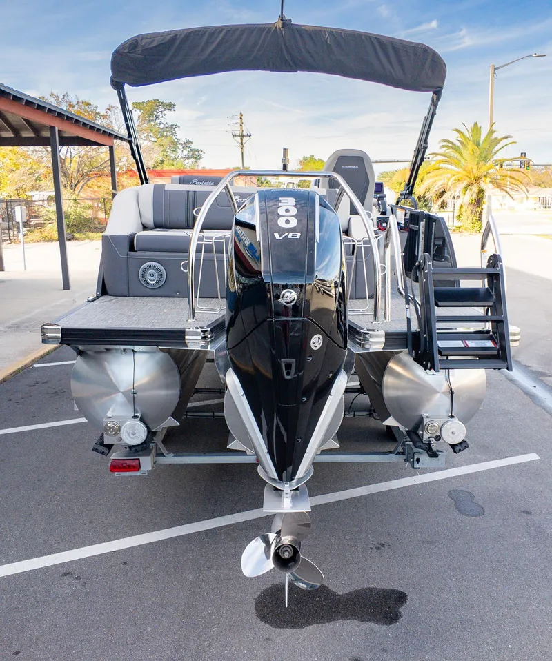 Slide: The Image of 2025 Barletta Corsa 23U pontoon boat with powerful V8 engine, parked outdoors. - 6